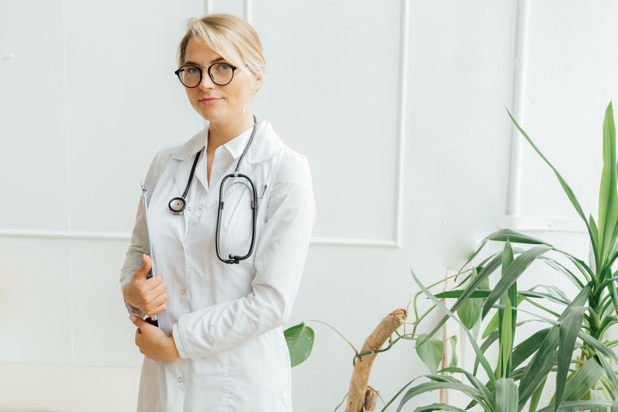 Female doctor in a white coat with a stethoscope